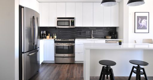 A spacious modern kitchen with stainless steel appliances.